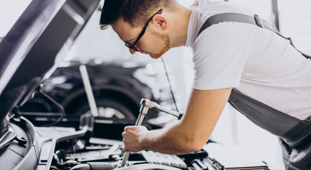 repair man making car service