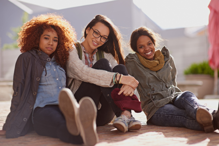 portrait female student floor campus break relax classes university face happy diverse friends school education women learners academics learning college